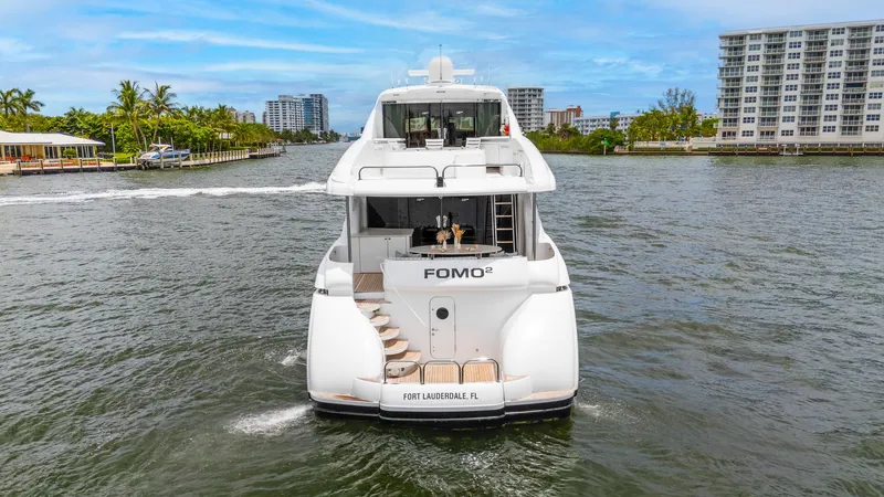Fomo2 Yacht Photos Pics Lazzara 80 Skylounge yacht cruising in Fort Lauderdale, 2002 model, rear view.