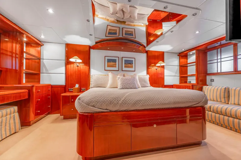 Fomo2 Yacht Photos Pics Luxurious bedroom interior of 2002 Lazzara 80 Skylounge yacht with elegant wood finishes.