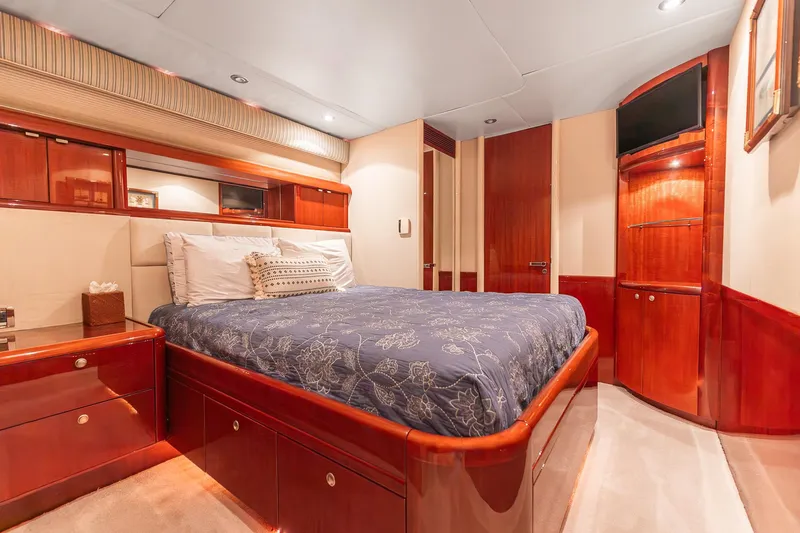 Fomo2 Yacht Photos Pics Luxurious bedroom interior of 2002 Lazzara 80 Skylounge yacht with elegant wood finishes.