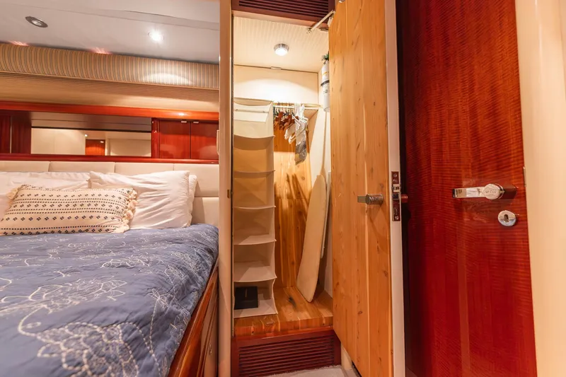 Fomo2 Yacht Photos Pics Luxurious bedroom interior of 2002 Lazzara 80 Skylounge yacht with closet and elegant bedding.