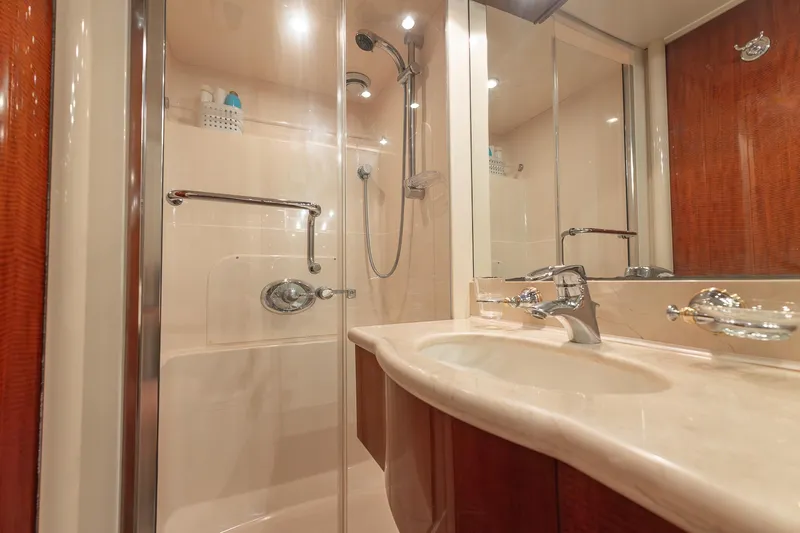 Fomo2 Yacht Photos Pics Luxurious bathroom in 2002 Lazzara 80 Skylounge yacht with modern shower and elegant sink.
