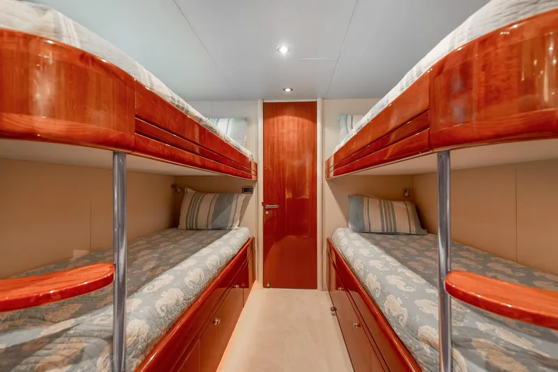 Fomo2 Yacht Photos Pics Luxurious 2002 Lazzara 80 Skylounge yacht cabin with elegant wooden bunk beds.