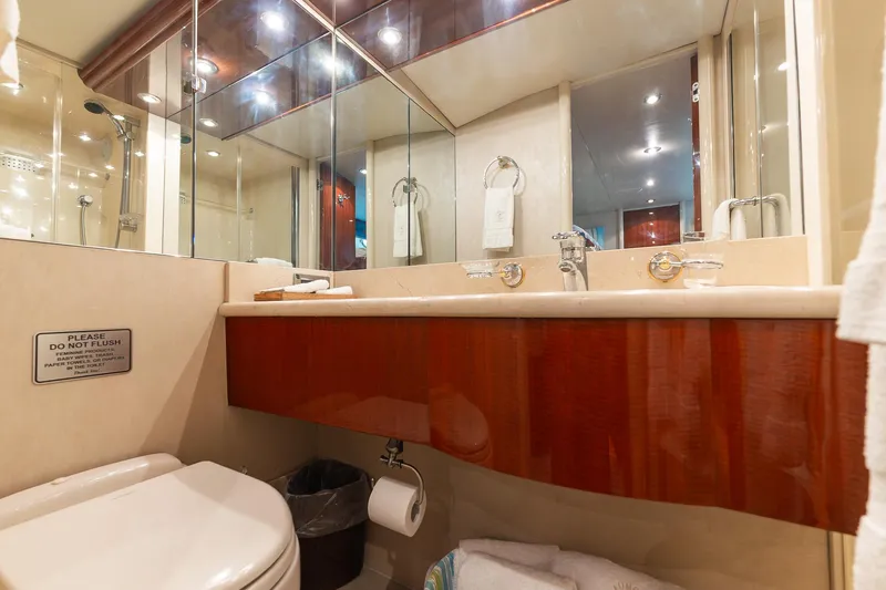 Fomo2 Yacht Photos Pics Luxurious bathroom in 2002 Lazzara 80 Skylounge yacht with elegant fixtures and mirrored cabinets.