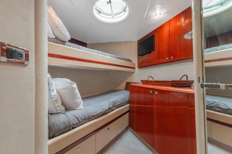 Fomo2 Yacht Photos Pics Luxurious cabin interior of 2002 Lazzara 80 Skylounge yacht with bunk beds and wood cabinetry.