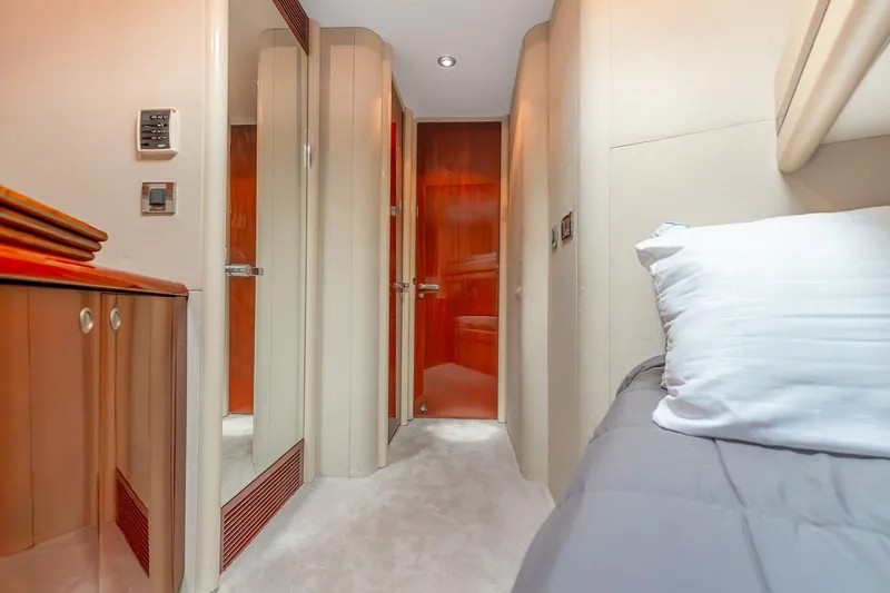 Fomo2 Yacht Photos Pics Luxurious interior of 2002 Lazzara 80 Skylounge yacht cabin with elegant wood finishes.