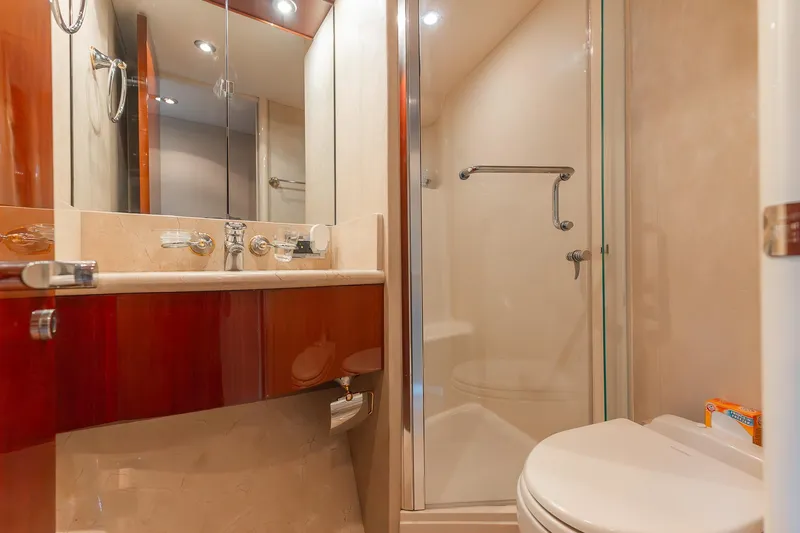 Fomo2 Yacht Photos Pics Luxurious bathroom in 2002 Lazzara 80 Skylounge yacht with shower and elegant fixtures.