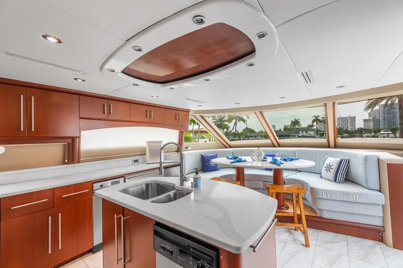 Fomo2 Yacht Photos Pics Luxurious interior of 2002 Lazzara 80 Skylounge yacht with modern kitchen and dining area.