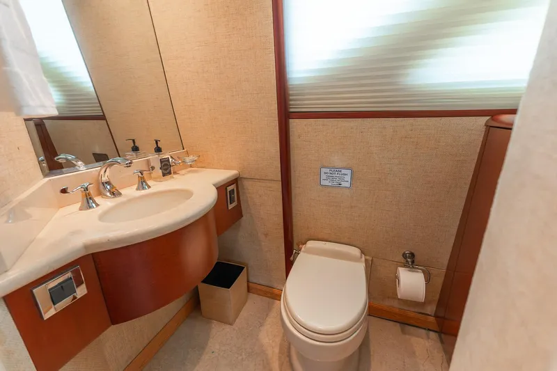 Fomo2 Yacht Photos Pics Luxurious bathroom in 2002 Lazzara 80 Skylounge yacht with modern fixtures and elegant design.