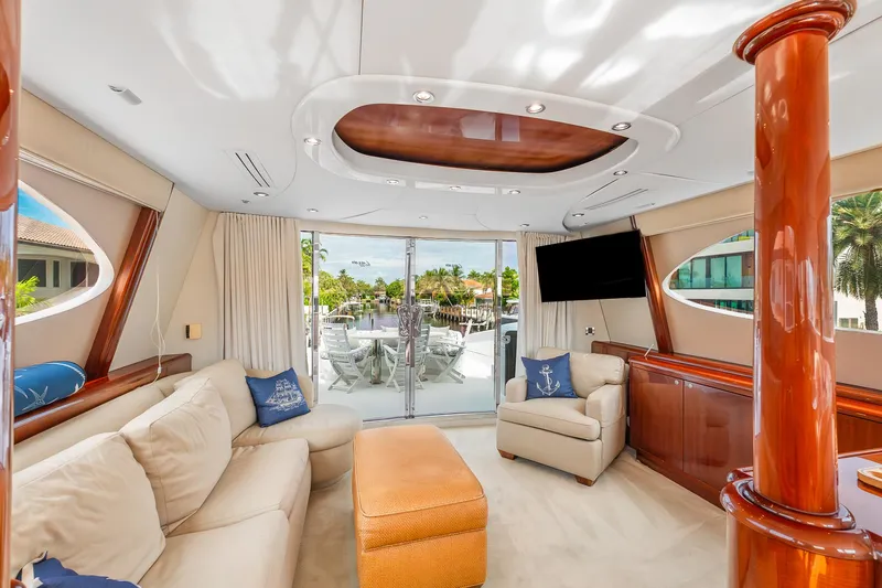 Fomo2 Yacht Photos Pics Luxurious interior of 2002 Lazzara 80 Skylounge yacht with elegant seating and large windows.
