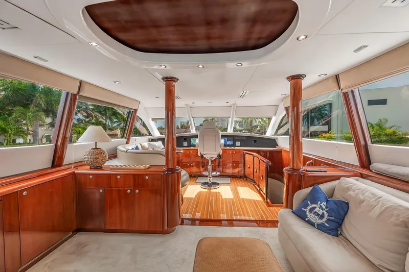 Fomo2 Yacht Photos Pics Luxurious interior of 2002 Lazzara 80 Skylounge yacht with elegant wood finishes and panoramic windows.