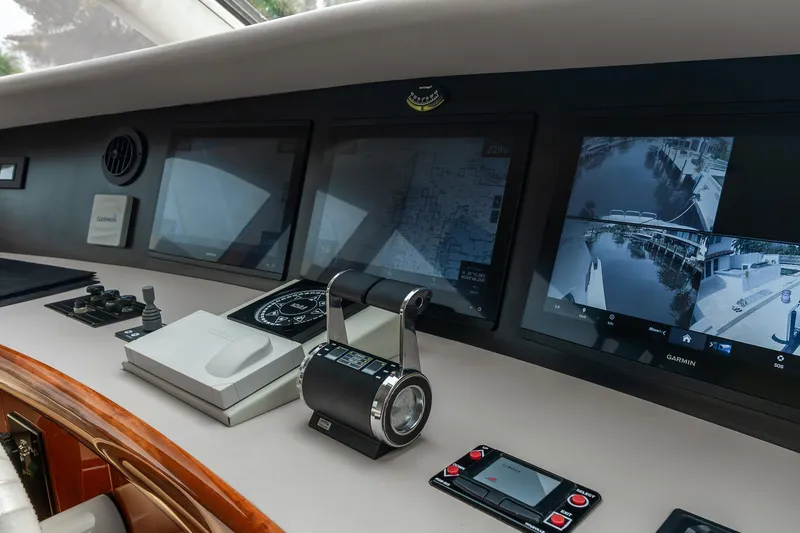 Fomo2 Yacht Photos Pics Control panel of 2002 Lazzara 80 Skylounge yacht with navigation screens and controls.
