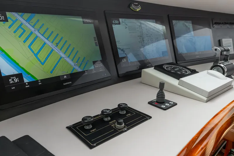 Fomo2 Yacht Photos Pics Control panel of 2002 Lazzara 80 Skylounge yacht with navigation screens and controls.