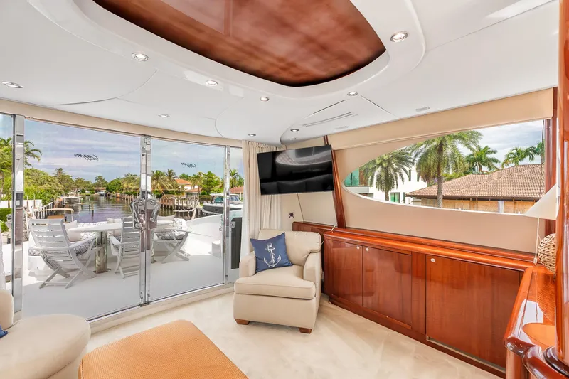 Fomo2 Yacht Photos Pics Luxurious interior of 2002 Lazzara 80 Skylounge yacht with elegant furnishings and canal view.
