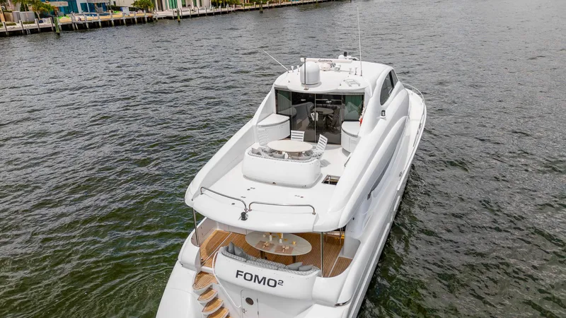 Fomo2 Yacht Photos Pics Luxury 2002 Lazzara 80 Skylounge yacht on water, featuring spacious deck and sleek design.