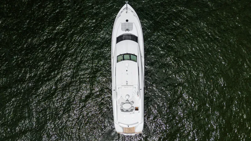 Fomo2 Yacht Photos Pics Aerial view of 2002 Lazzara 80 Skylounge yacht on open water.