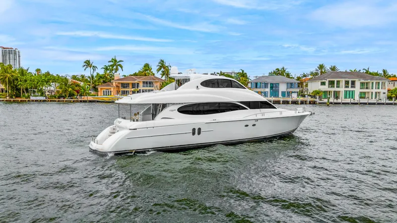 Fomo2 Yacht Photos Pics Luxury 2002 Lazzara 80 Skylounge yacht cruising near waterfront homes.