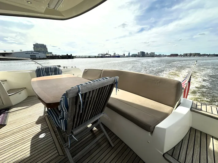  Yacht Photos Pics Luxury yacht deck with seating area, Prestige 500, 2013 model, cruising on open water.