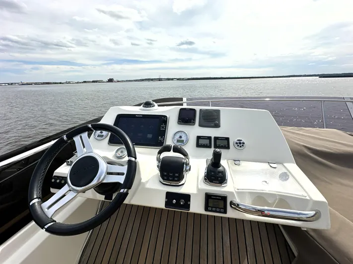  Yacht Photos Pics Helm of 2013 Prestige 500 yacht with steering wheel and control panel on open water.