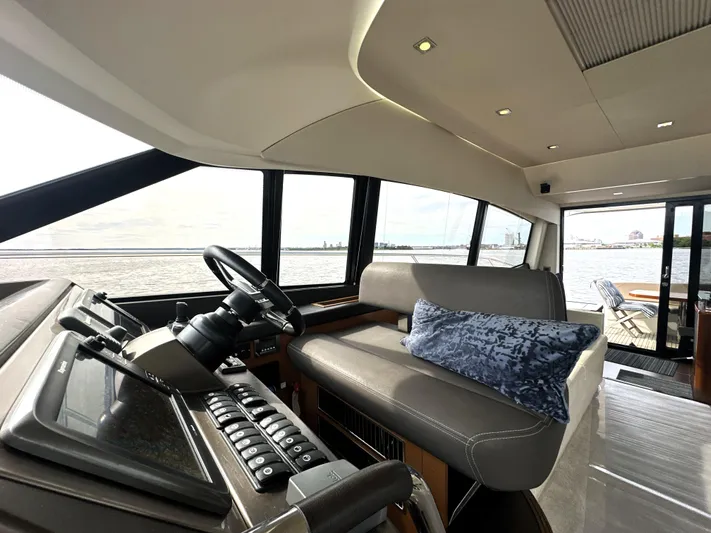  Yacht Photos Pics Interior of 2013 Prestige 500 yacht with helm, seating, and ocean view.