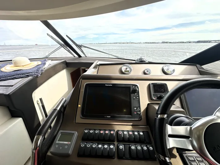  Yacht Photos Pics Cockpit of 2013 Prestige 500 yacht with navigation controls and steering wheel.