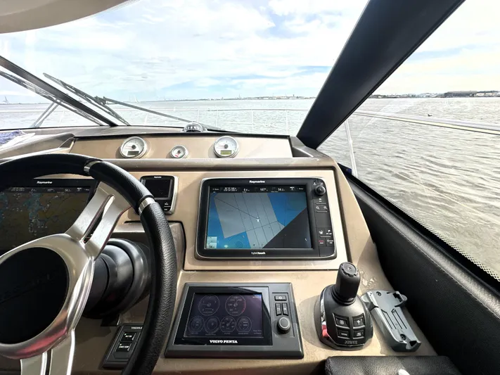  Yacht Photos Pics Cockpit view of 2013 Prestige 500 yacht with navigation controls and steering wheel.