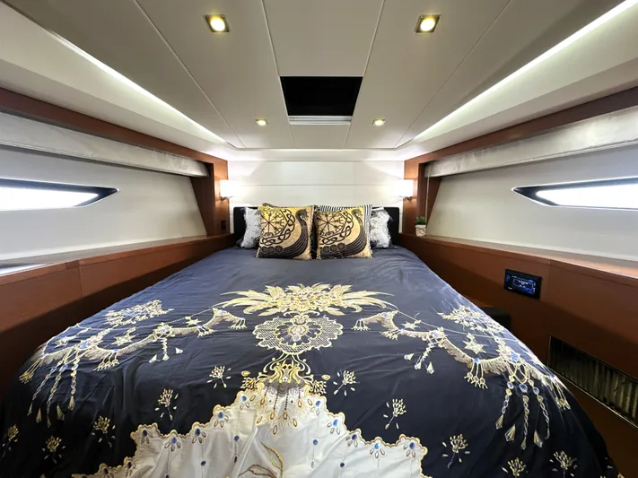  Yacht Photos Pics Luxurious cabin interior of a 2013 Prestige 500 yacht with elegant bedding and ambient lighting.