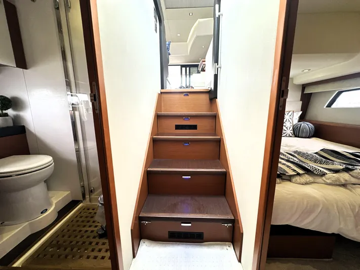  Yacht Photos Pics Interior of 2013 Prestige 500 yacht showing stairs, bathroom, and bedroom.