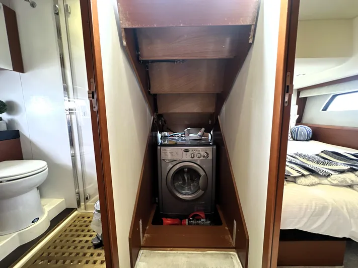  Yacht Photos Pics Laundry area with washing machine in 2013 Prestige 500 yacht, adjacent to bathroom and bedroom.