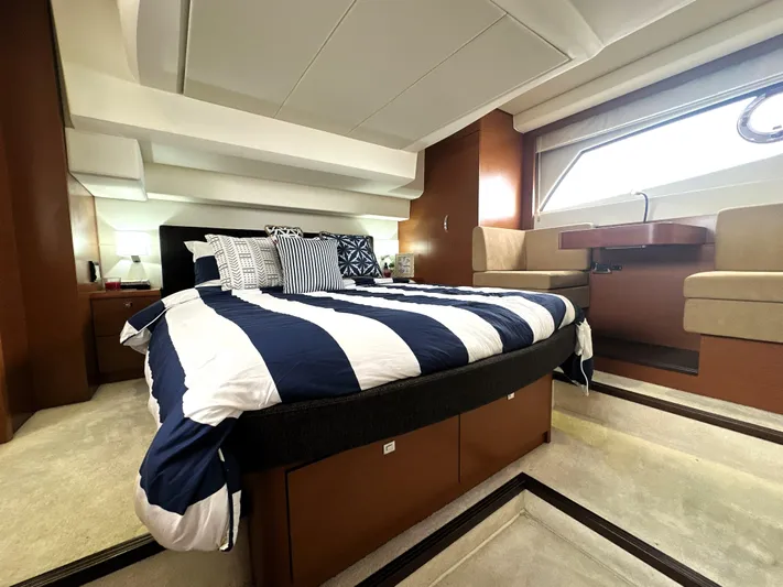  Yacht Photos Pics Luxurious cabin interior of a 2013 Prestige 500 yacht with striped bedding and modern furnishings.