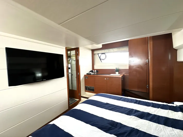  Yacht Photos Pics Luxurious cabin interior of 2013 Prestige 500 yacht with modern amenities and striped bedding.