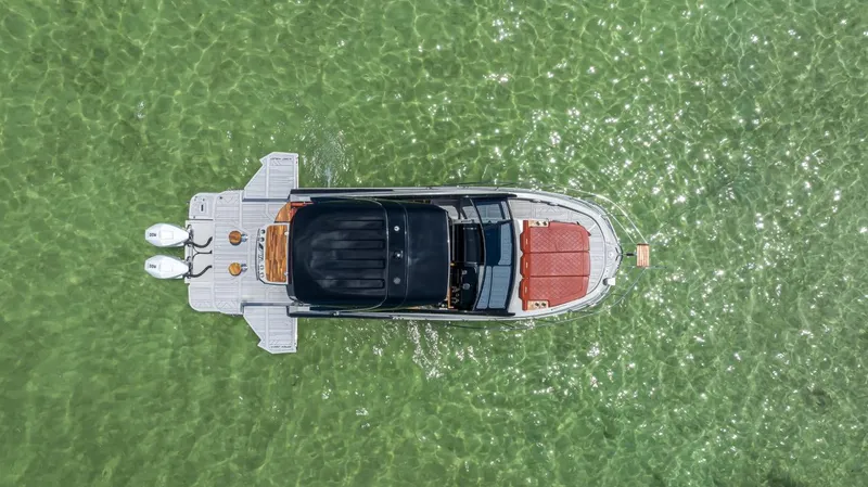  Yacht Photos Pics Aerial view of 2024 NHD 355 Open Deck boat on clear green water.