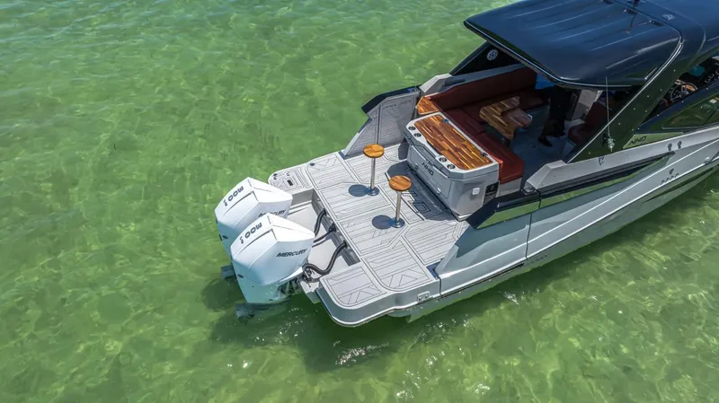  Yacht Photos Pics 2024 NHD 355 Open Deck boat on clear green water, featuring dual outboard engines.