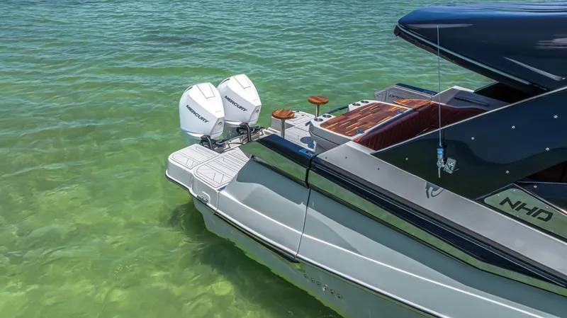  Yacht Photos Pics 2024 NHD 355 Open Deck boat with twin engines on clear water.