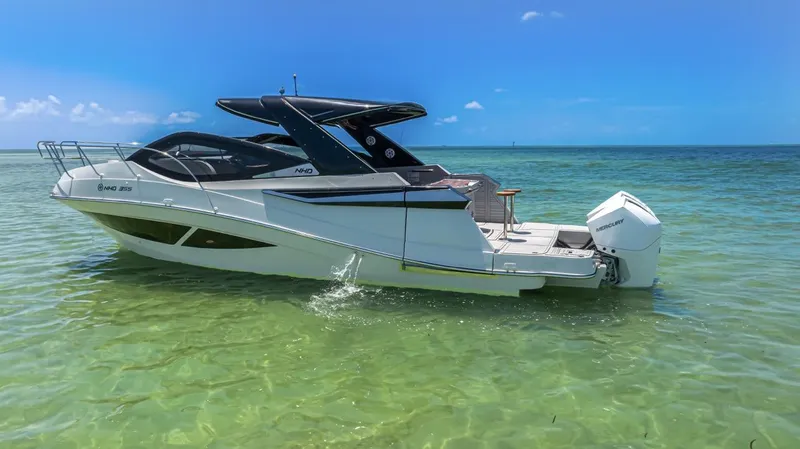  Yacht Photos Pics 2024 NHD 355 Open Deck boat on clear turquoise water under blue sky.