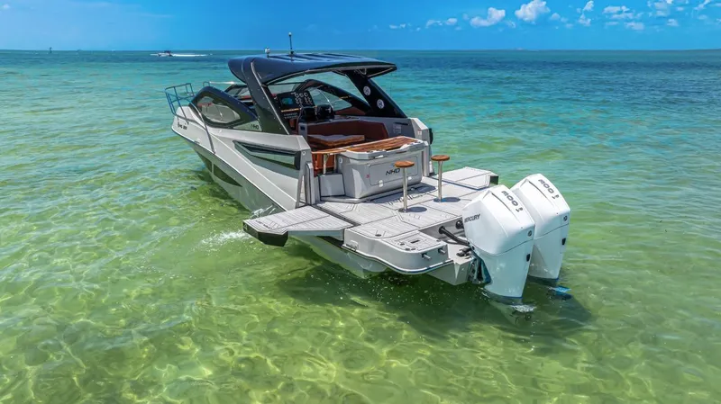  Yacht Photos Pics 2024 NHD 355 Open Deck boat in clear turquoise water, rear view.
