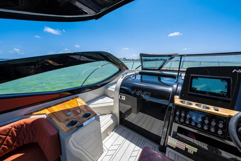  Yacht Photos Pics 2024 NHD 355 Open Deck boat interior with modern dashboard and scenic ocean view.