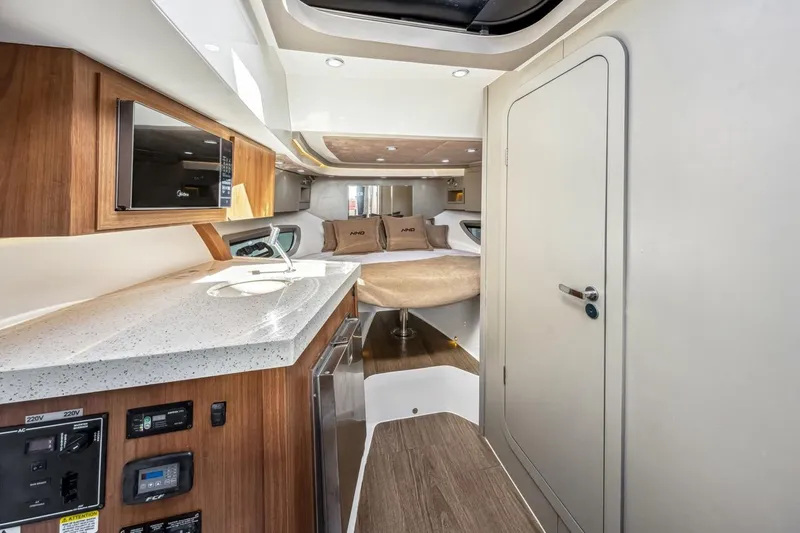 Yacht Photos Pics 2024 NHD 355 Open Deck interior with modern kitchen and cozy sleeping area.