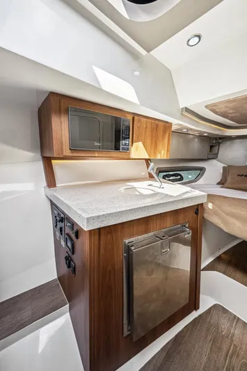  Yacht Photos Pics 2024 NHD 355 Open Deck interior with kitchenette, featuring microwave and compact fridge.