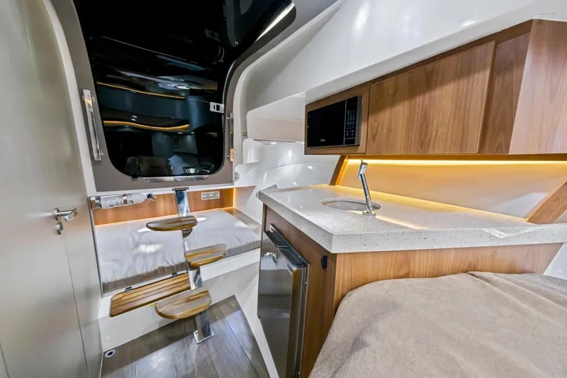  Yacht Photos Pics Luxurious interior of 2024 NHD 355 Open Deck boat with modern kitchen and wooden accents.