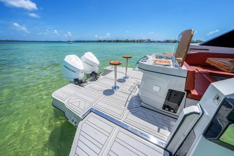  Yacht Photos Pics 2024 NHD 355 Open Deck boat with dual engines on clear turquoise water.