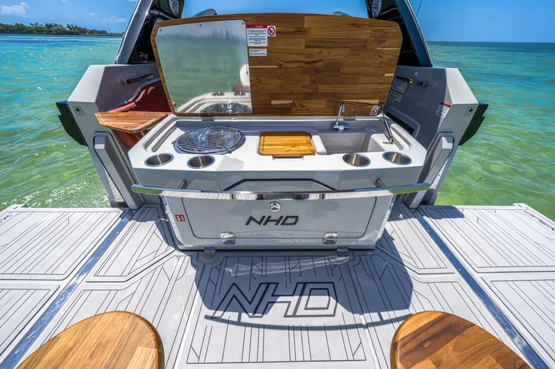  Yacht Photos Pics 2024 NHD 355 Open Deck boat with outdoor kitchen on turquoise water.