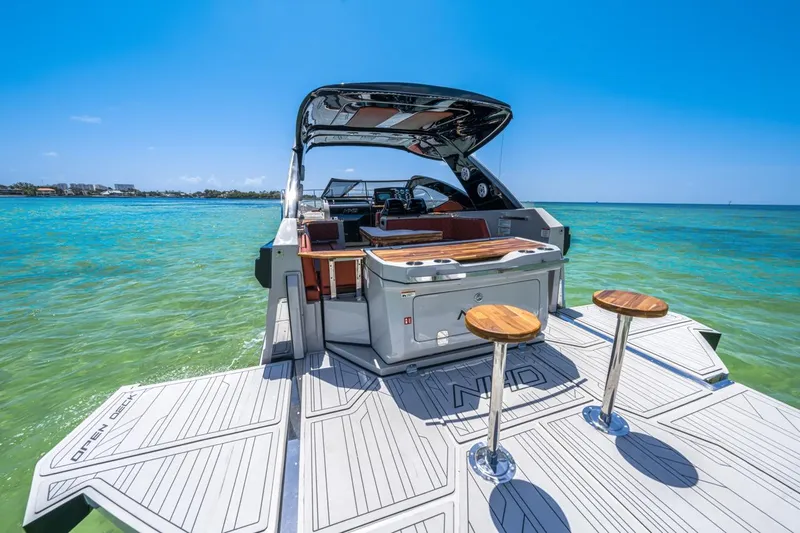  Yacht Photos Pics 2024 NHD 355 Open Deck boat on clear blue water, featuring a spacious deck.