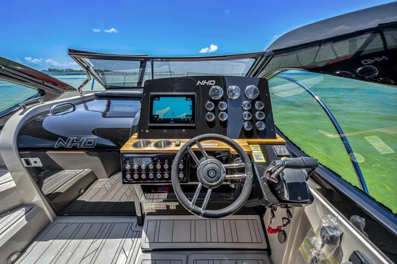  Yacht Photos Pics 2024 NHD 355 Open Deck boat cockpit with modern controls and navigation system.