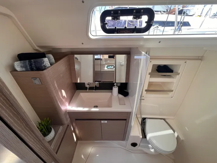 Sfo 418 #289 In Stock Yacht Photos Pics Modern bathroom in 2023 Hanse 418 yacht with sink, mirror, and toilet.