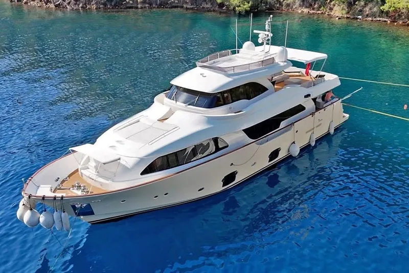  Yacht Photos Pics Luxurious 2011 Custom Line Navetta 26 yacht anchored in clear blue waters.