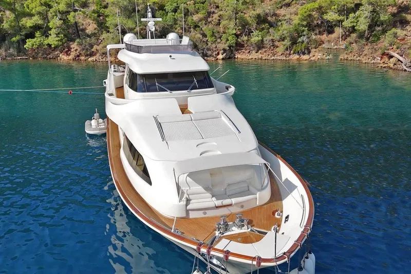  Yacht Photos Pics Luxurious 2011 Custom Line Navetta 26 yacht anchored in serene turquoise waters.