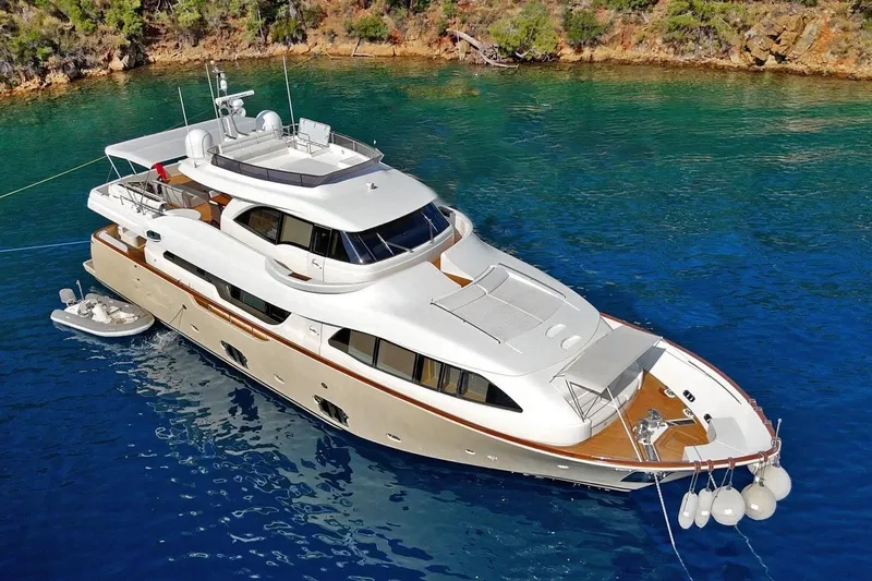  Yacht Photos Pics Luxurious 2011 Custom Line Navetta 26 yacht anchored in clear blue waters.