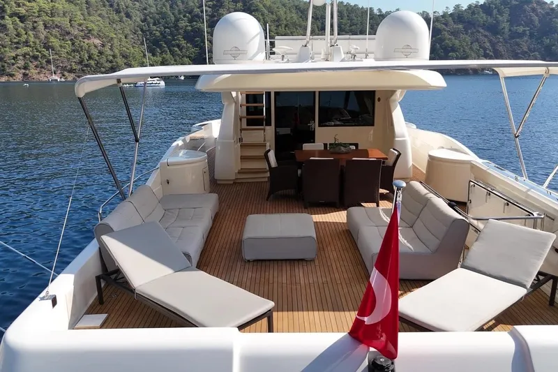  Yacht Photos Pics Luxurious 2011 Custom Line Navetta 26 yacht deck with seating, dining area, and scenic view.