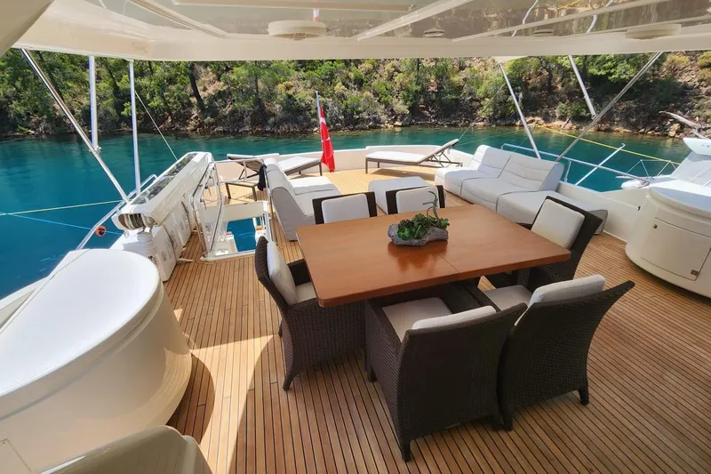  Yacht Photos Pics Luxurious 2011 Custom Line Navetta 26 yacht deck with dining area and scenic water view.