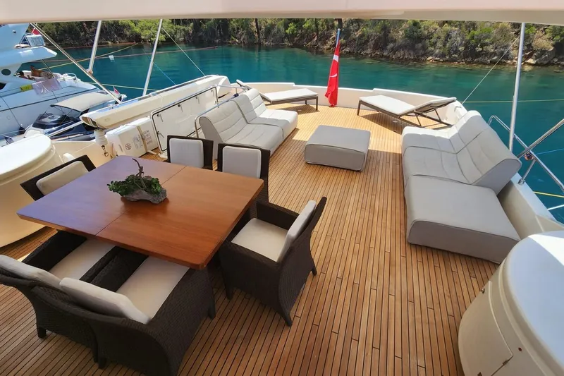  Yacht Photos Pics Luxurious 2011 Custom Line Navetta 26 yacht deck with elegant seating and dining area.